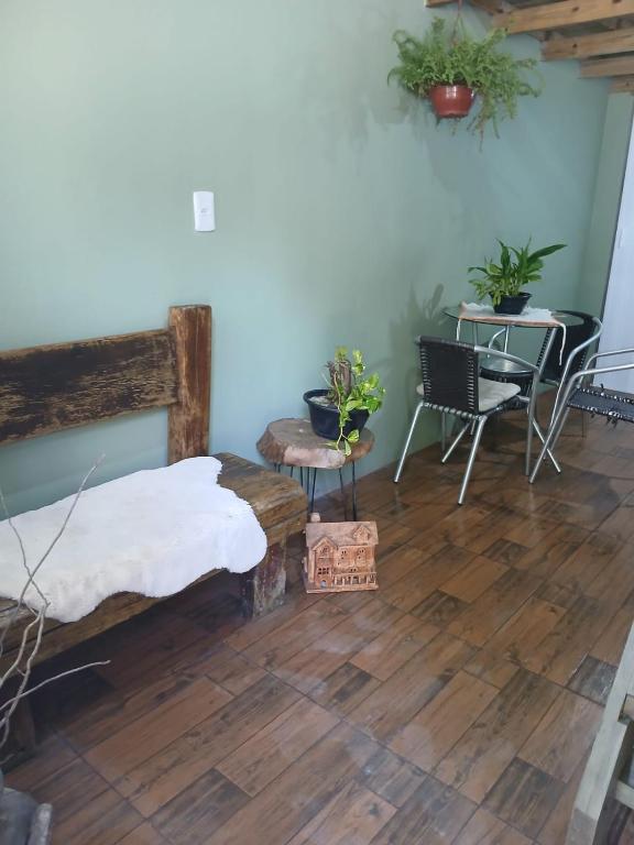 a bedroom with a bed and a table and chairs at Tatiane cristino in Imbituba