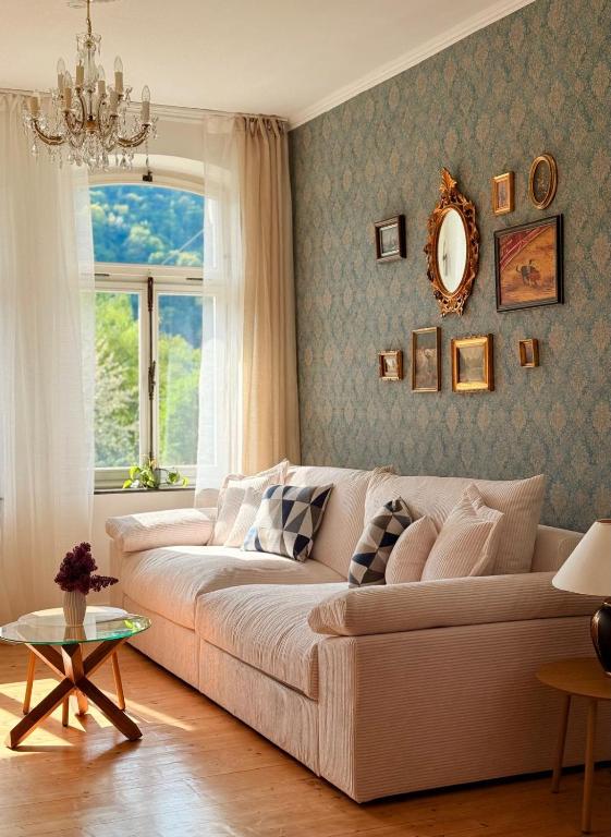 a living room with a couch and a window at Villa Rheinblick 1 OG in Kamp-Bornhofen