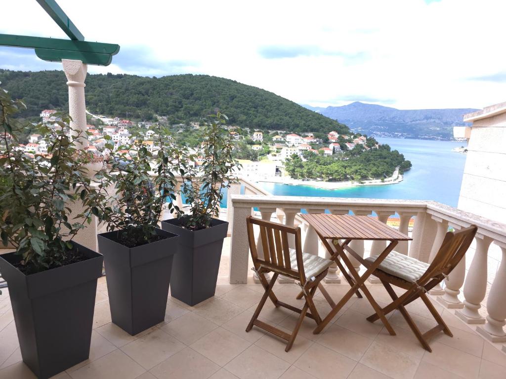a table and chairs on a balcony with a view at Dream - sea view apartment in Pučišća