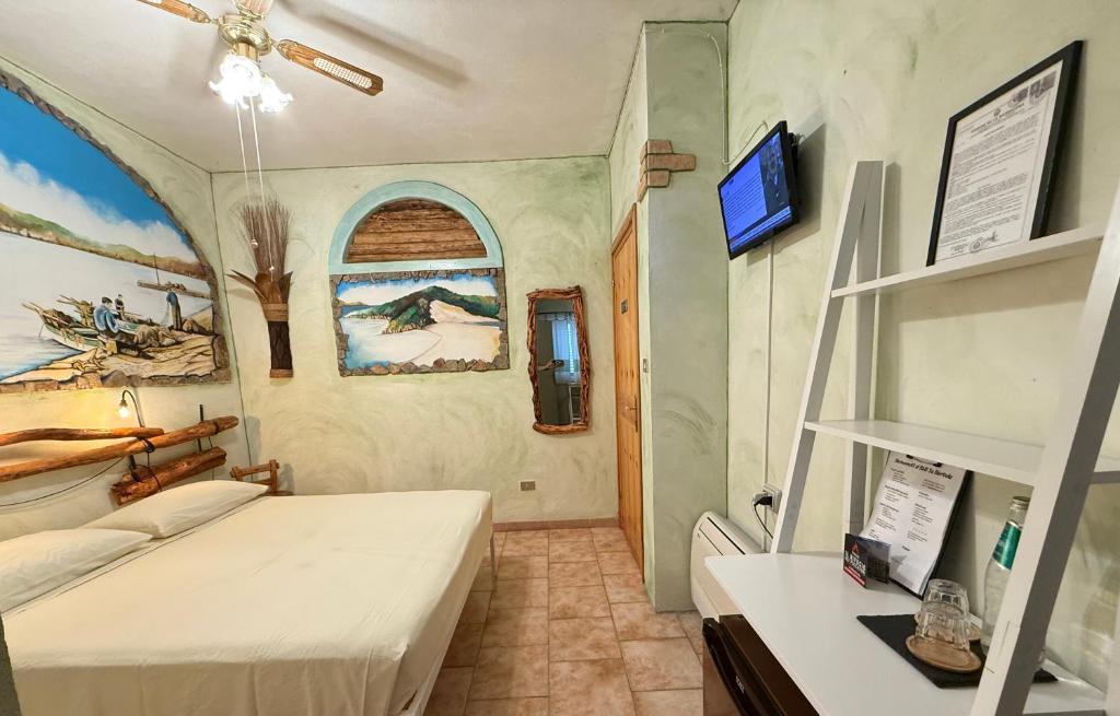 a room with two beds and a shelf in it at B&B Sa Bèrtula in La Maddalena