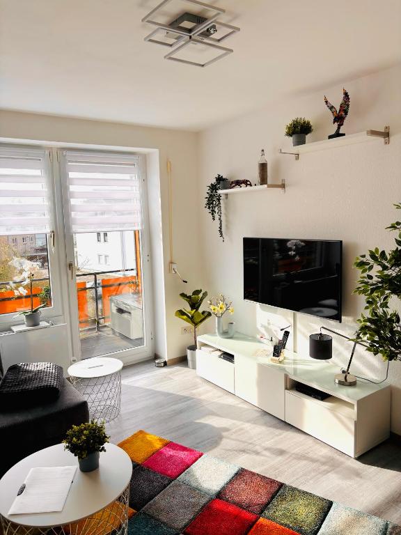a living room with a couch and a tv at MeerZeit in Dahme