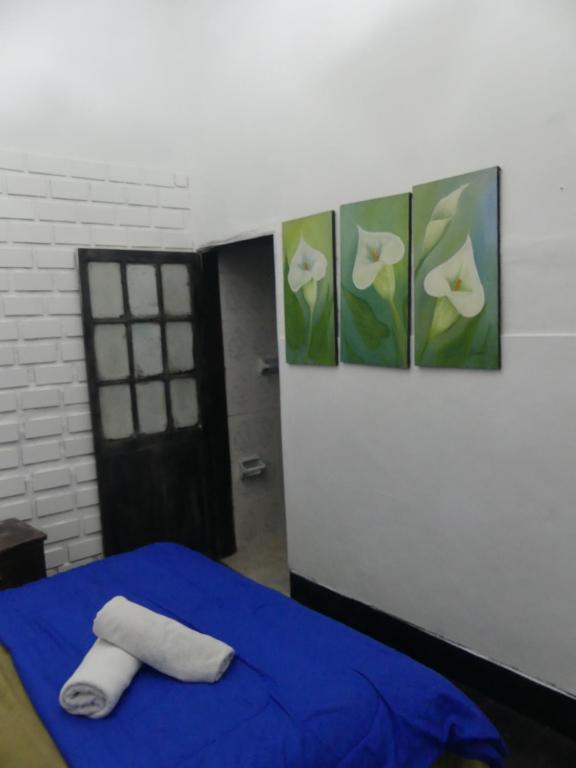 Postel nebo postele na pokoji v ubytování Hostal Hanoi en Bogotá