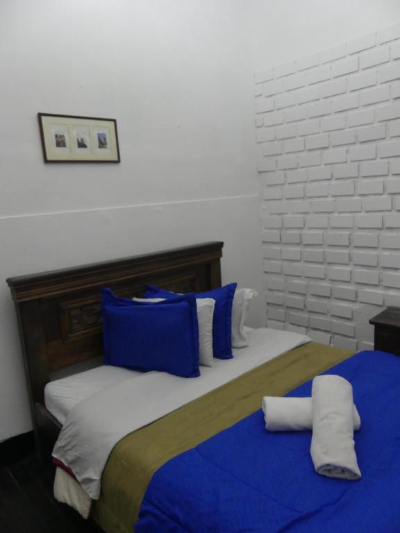 Postel nebo postele na pokoji v ubytování Hostal Hanoi en Bogotá