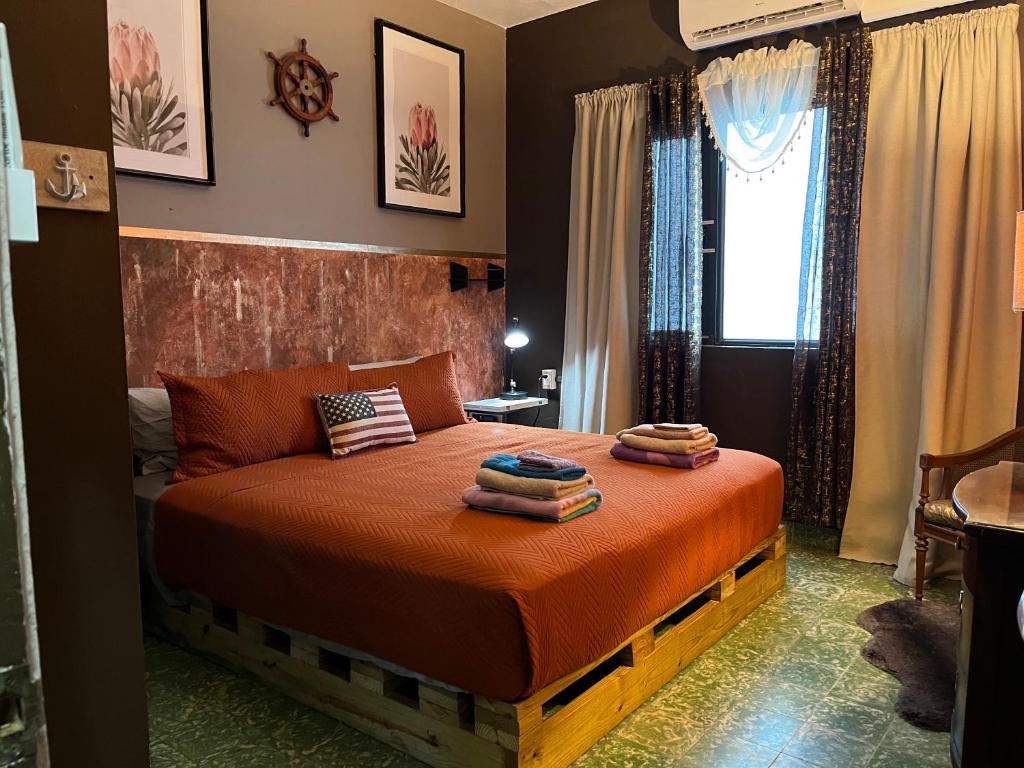 a bedroom with a bed with two pillows on it at Lower Price, More Style, Discount Studio In San Juan,Pr, Beach, Free Bikes in San Juan