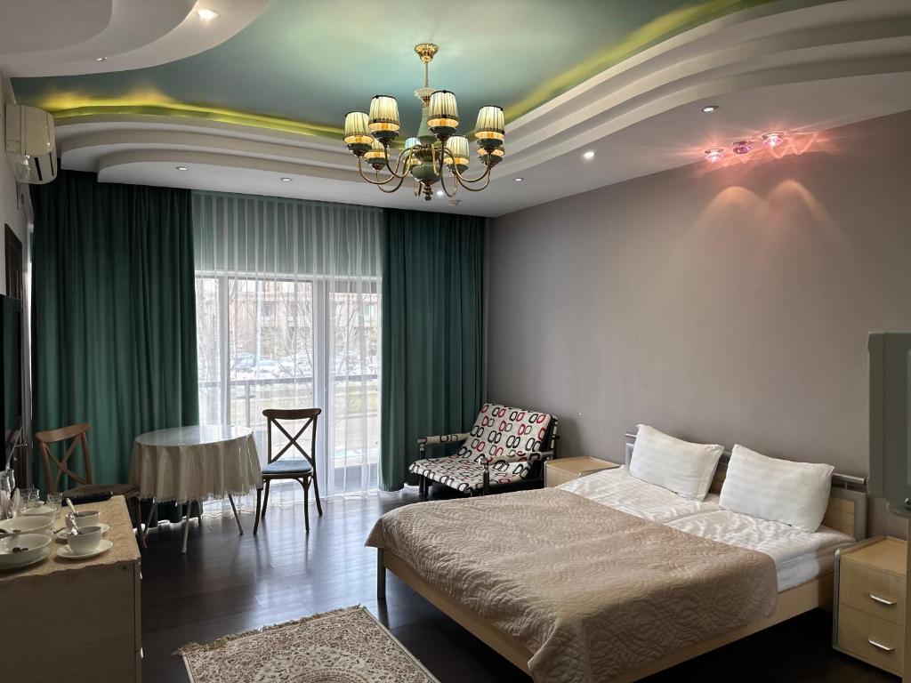 a bedroom with a bed and a living room at Dostyq in Astana