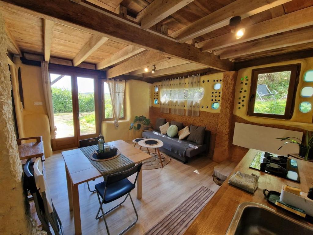 a living room with a couch and a table at Organic and artistic home in Payrignac