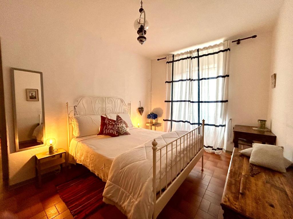 a bedroom with a bed and a large window at Blue Breeze Apartment in Germignaga