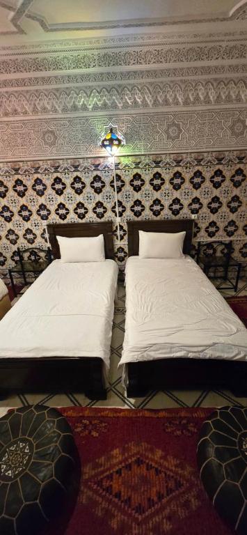 Postel nebo postele na pokoji v ubytování Riad Raffaa