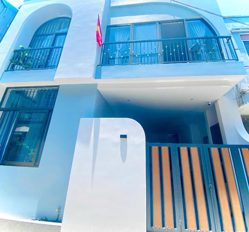 a blue and white building with a balcony at HG House in Da Nang