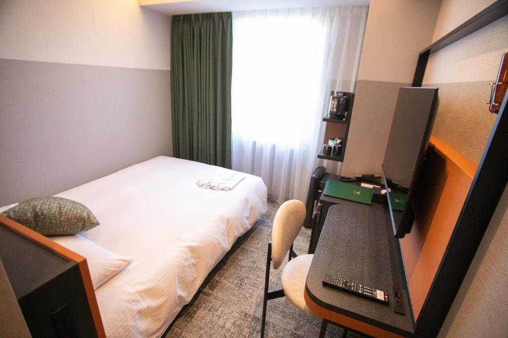 Postel nebo postele na pokoji v ubytování Wishton Hotel Yukari