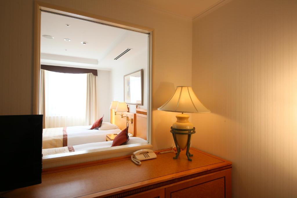 Postel nebo postele na pokoji v ubytování Wishton Hotel Yukari