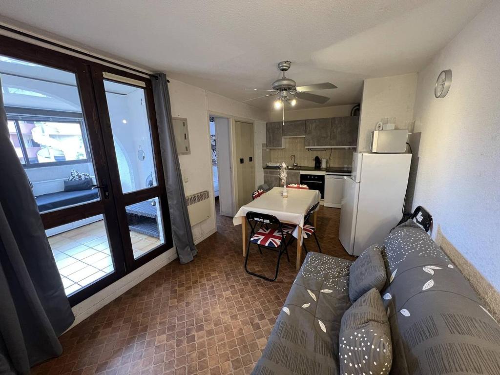 un salon avec un canapé et une cuisine dans l'établissement T2 Bord de Plage - 4 Pers - Parking Privé - FR-1-81-635, à Port-Leucate