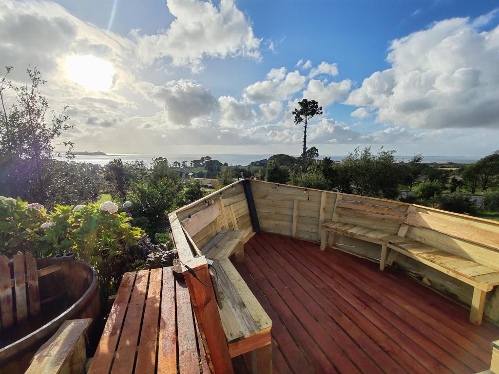 a wooden bench sitting on top of a wooden deck at domoschiloe in Ancud