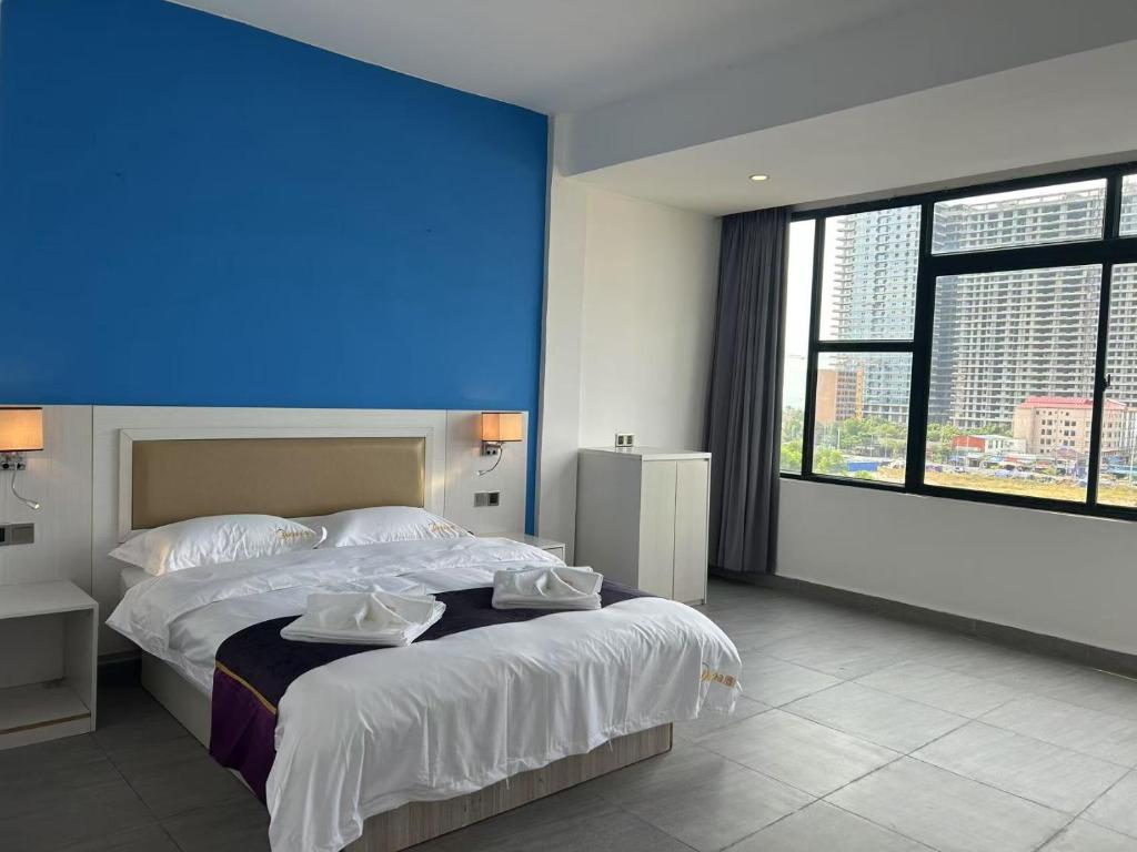 Postel nebo postele na pokoji v ubytování Midea Hotel 美的酒店 សណ្ឋាគារ មីឌា