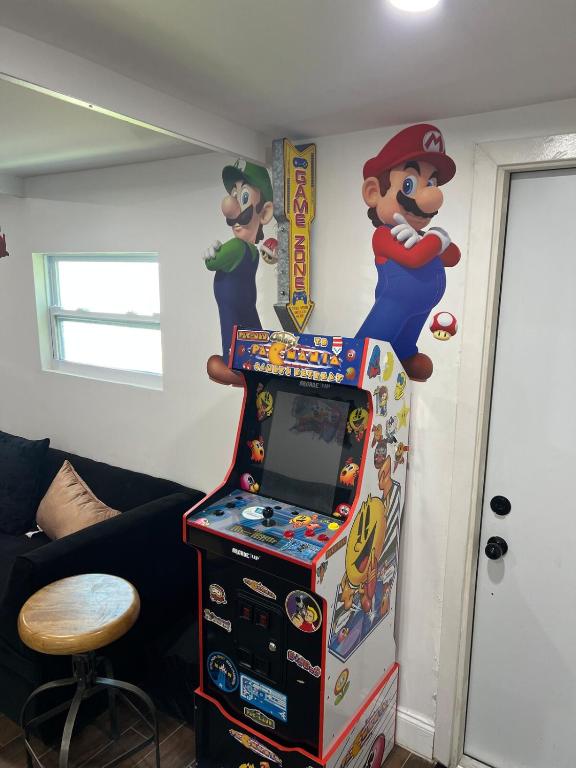 a video game arcade with a mario game at Miramar Retreat Arcade Game Room King Bed 25 Min to Hollywood Beach in Miramar