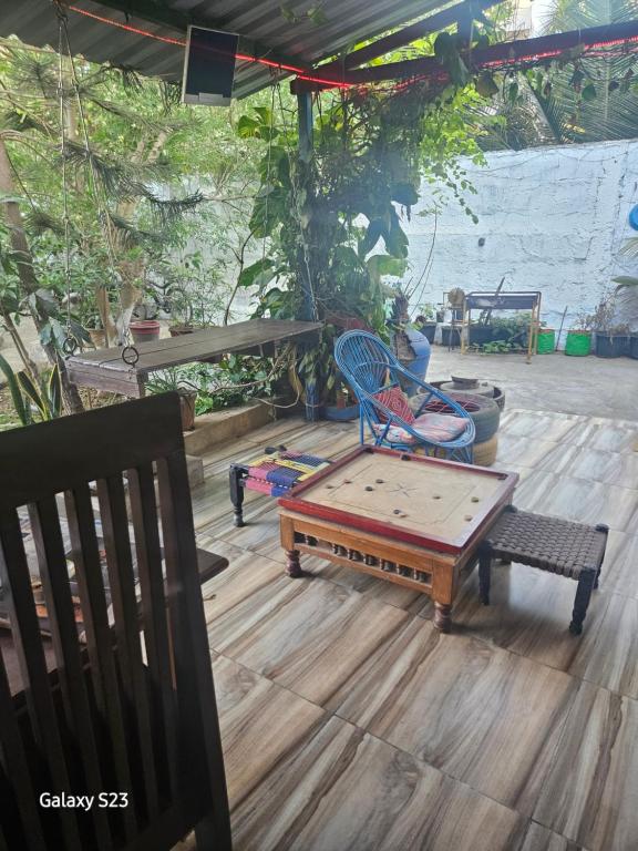 a patio with two chairs and a table at Dream Vision Guest House in Diu