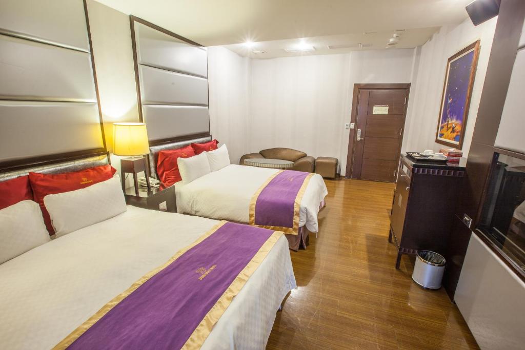 Postel nebo postele na pokoji v ubytování Spring Breeze Hotel