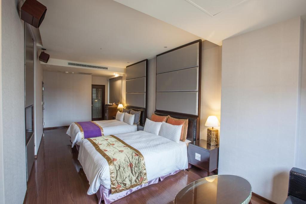 Postel nebo postele na pokoji v ubytování Spring Breeze Hotel