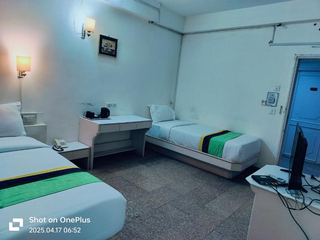 Postel nebo postele na pokoji v ubytování Hotel Crown