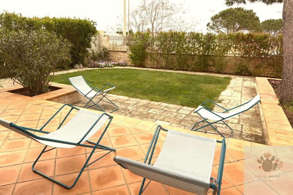 a group of chairs sitting on a patio at Villa Rossi in Polignano a Mare