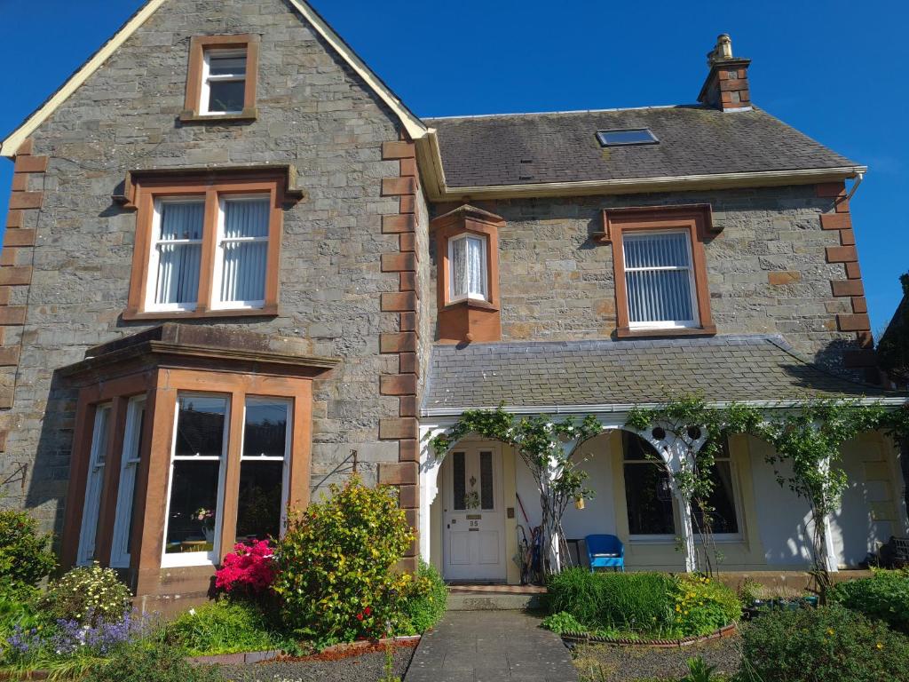 a brick house with a white door at 95 St Mary Street in Kirkcudbright