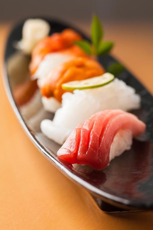 a plate of sushi with meat and vegetables on it at Shin Yokohama Prince Hotel in Yokohama