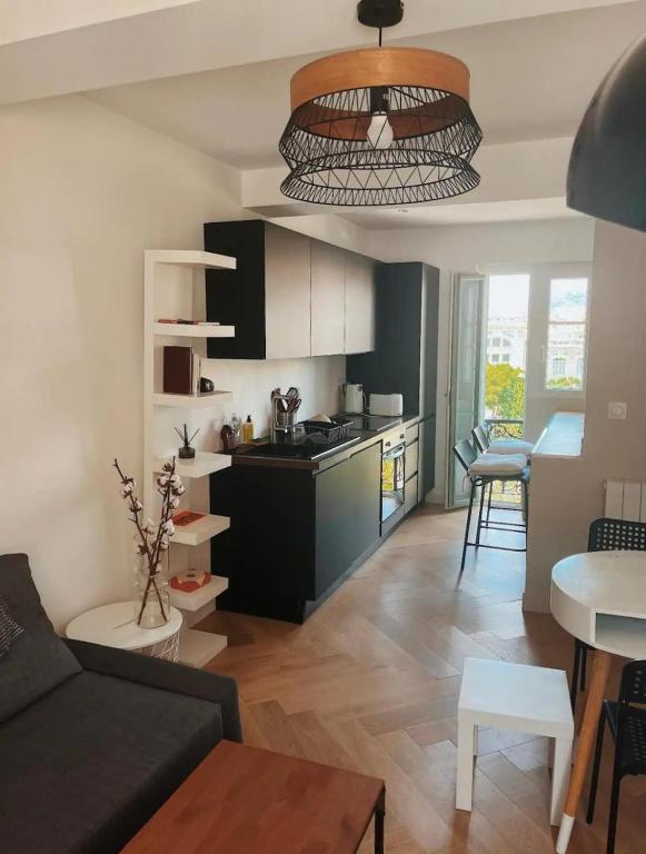 un salon avec un canapé et une cuisine dans l'établissement Nice vieille ville appartement design, proche de tout, à Nice