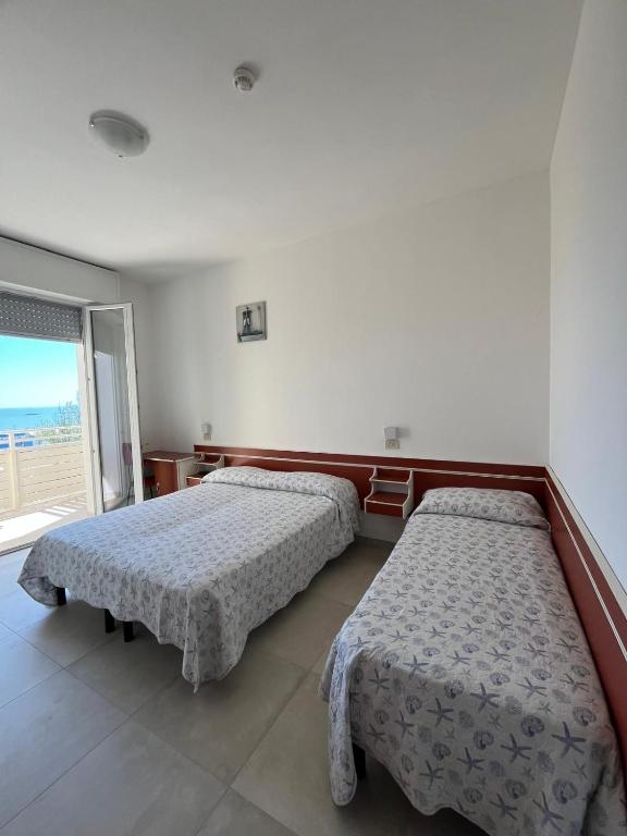 Postel nebo postele na pokoji v ubytování Hotel Flora