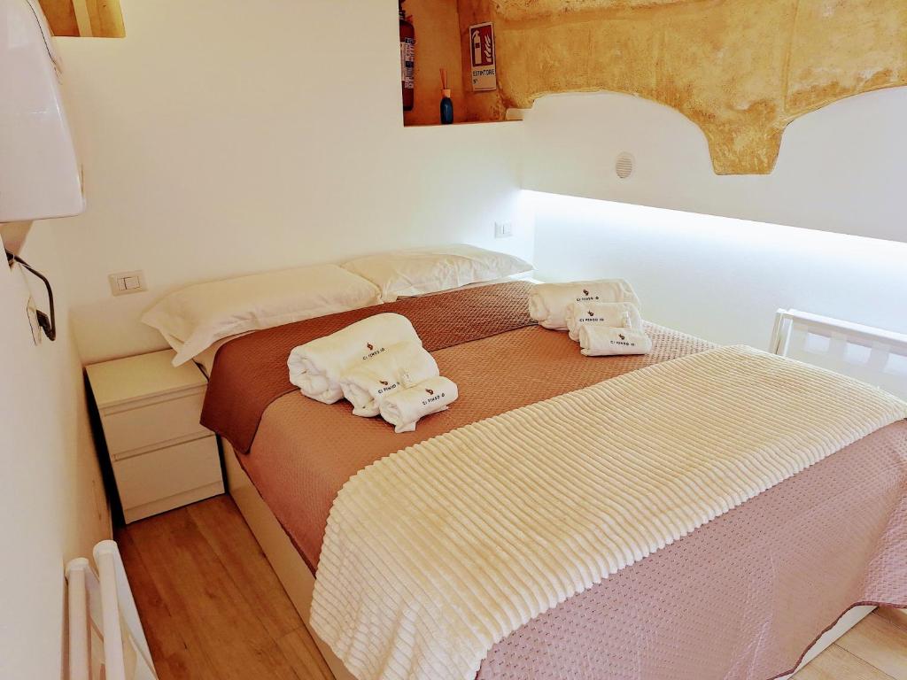 a bedroom with a bed with towels on it at Vico Farinella 12 Small Room in Polignano a Mare