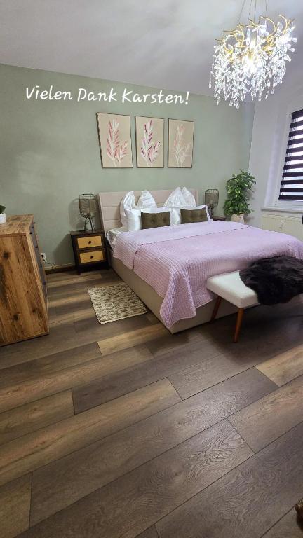 a bedroom with a bed and a chandelier at Cozy Pet-Friendly Apartment in Meißen