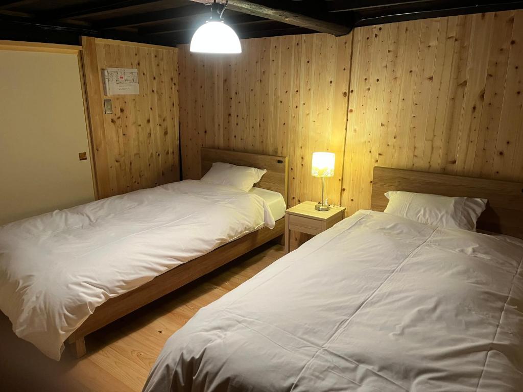 Postel nebo postele na pokoji v ubytování Matsumuraya Koma