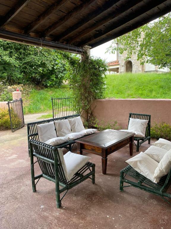 a patio with two chairs and a table and a couch at El Mirador de Abionzo in Abionzo