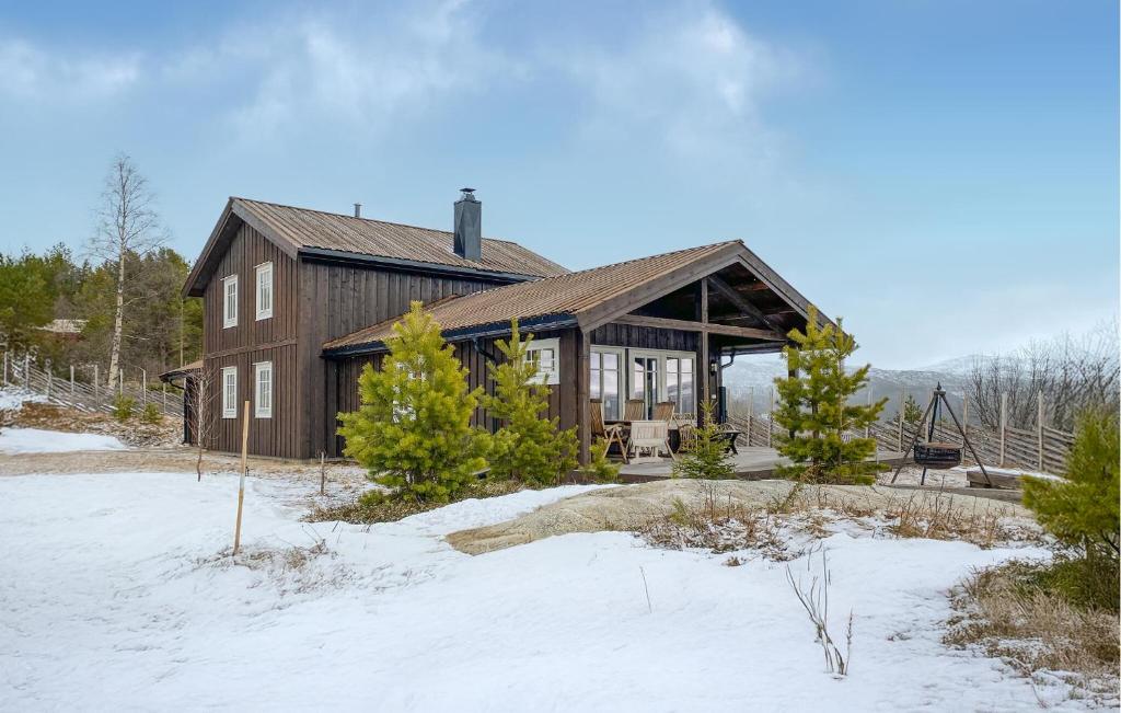a large wooden house in the snow at Gorgeous Home In Oppdal With Wifi in Oppdal