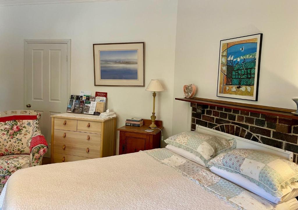 a bedroom with a bed and a dresser at OLDGREENWELLS B&B in Walcha