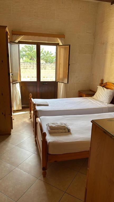 Postel nebo postele na pokoji v ubytování Nawrat Farmhouse