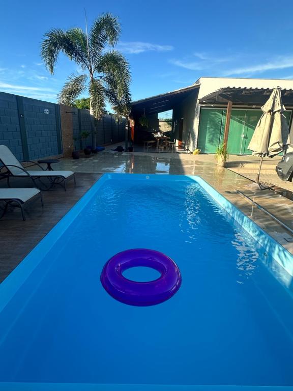 a blue swimming pool with a frisbee in it at Vila dos ventos in Marataizes