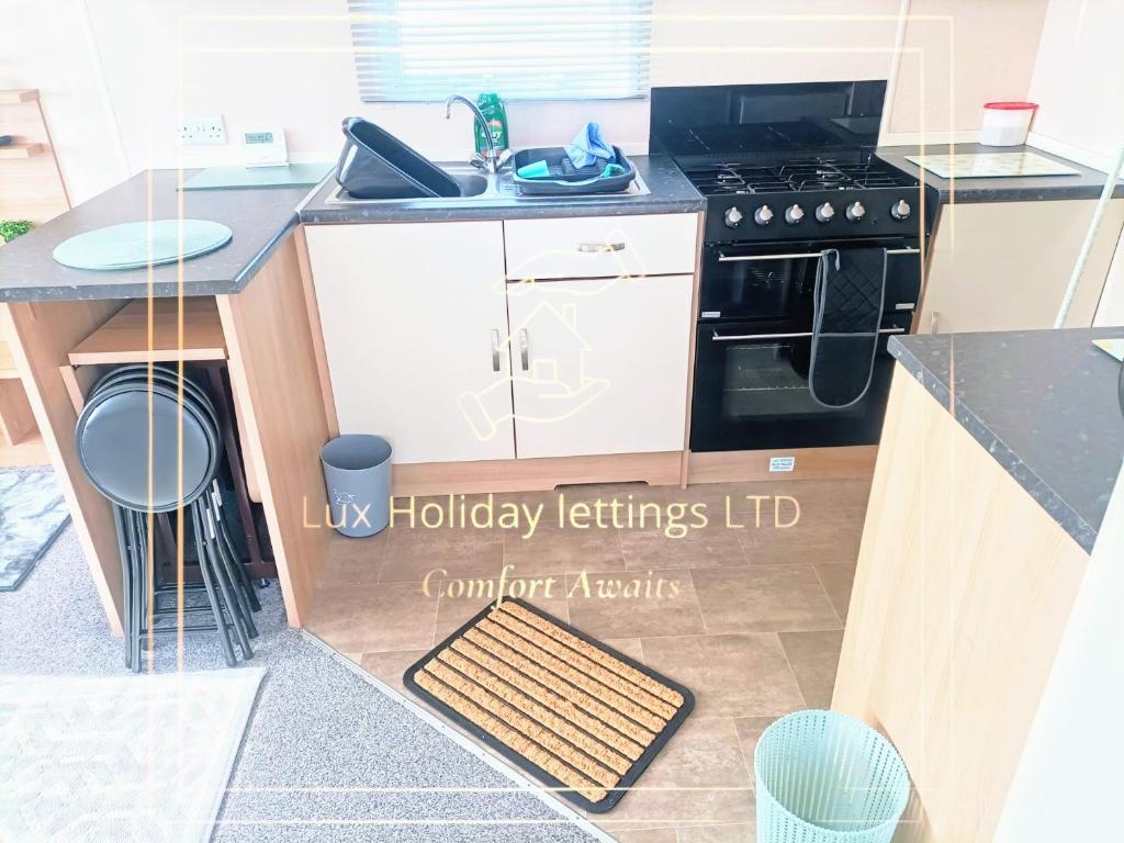 a kitchen with a sink and a stove at Seaside pet friendy escape butlins in Ingoldmells