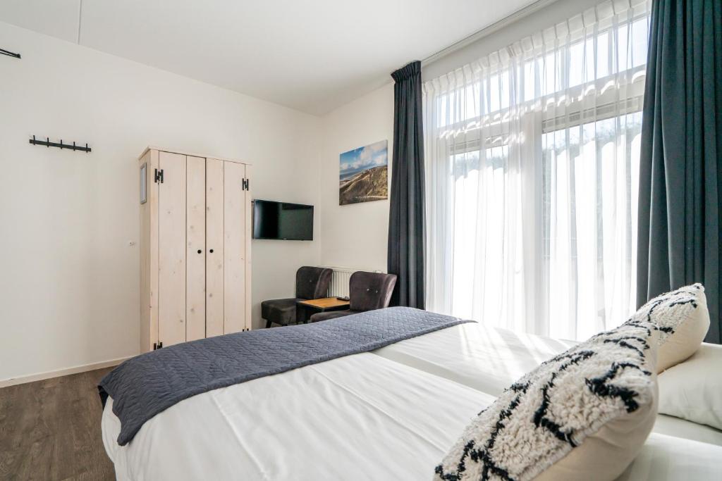 Postel nebo postele na pokoji v ubytování Duinhotel Haga