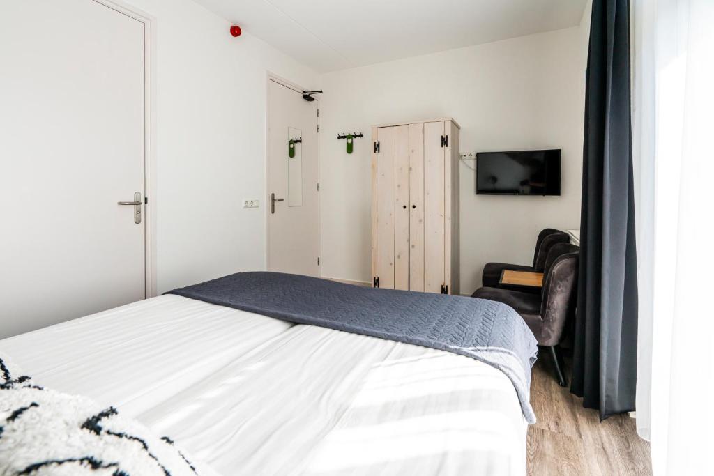Postel nebo postele na pokoji v ubytování Duinhotel Haga
