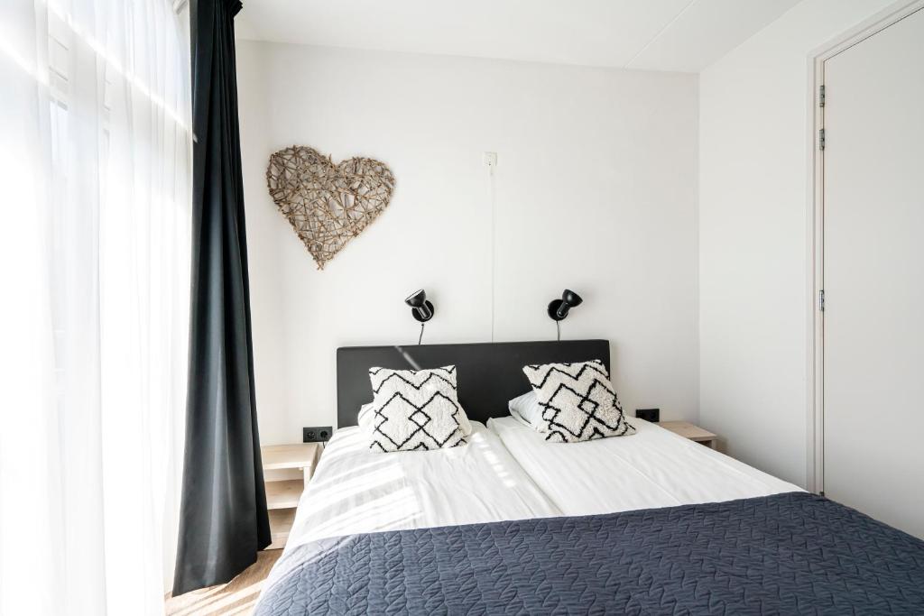 Postel nebo postele na pokoji v ubytování Duinhotel Haga