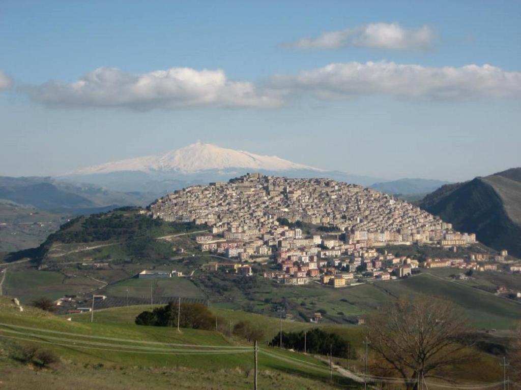 una ciudad en una colina con una montaña en el fondo en Casa Vacanze Villa Mariano, en Gangi