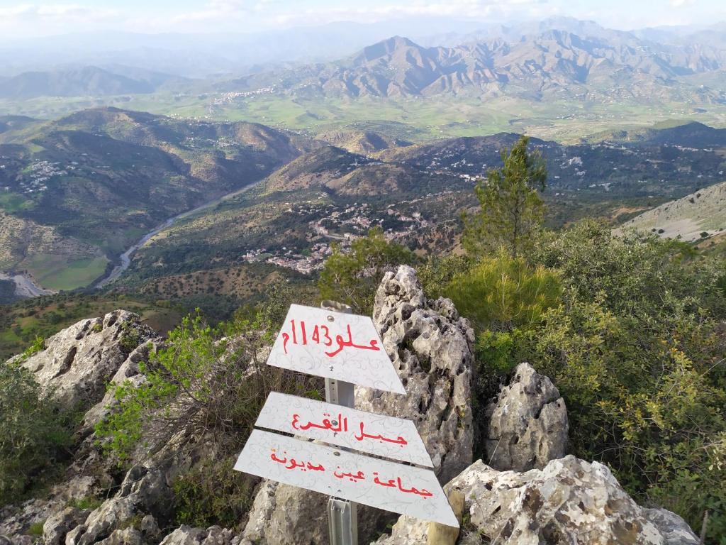 a sign sitting on top of a mountain at Gite touristique bouknala in Abinane