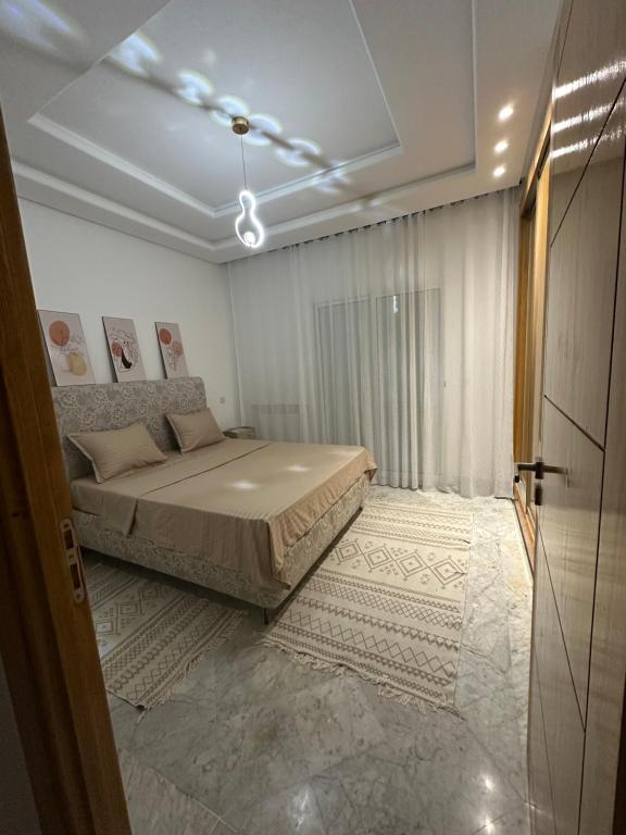 a bedroom with a large bed in a room at Luxury suite jardin de Carthage in Sidi Daoud