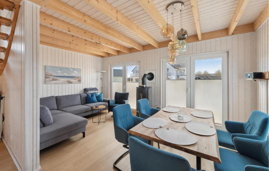 a living room with a table and blue chairs at Seeräuber Koje in Olpenitzdorf