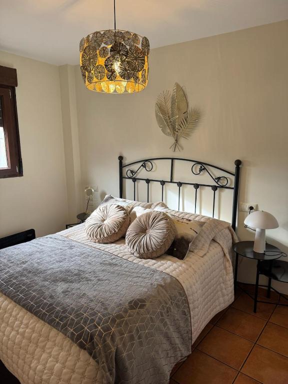 a bedroom with a bed with two pillows on it at El Escondite de Aragón in Mora de Rubielos