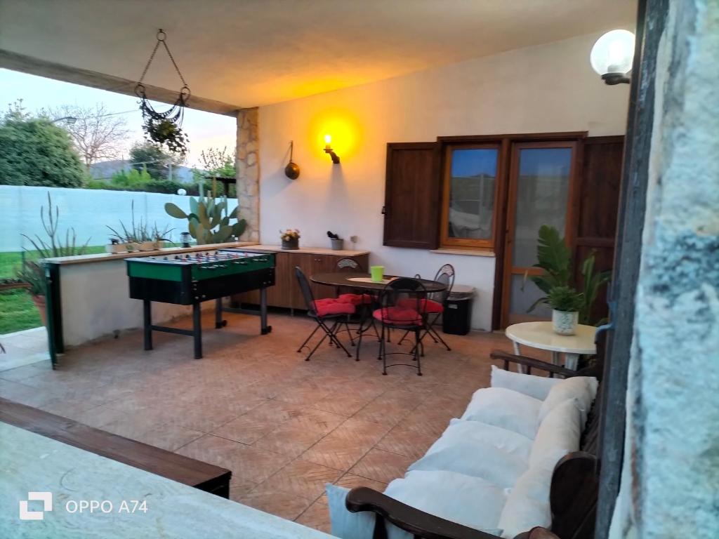 a living room with a couch and a ping pong table at Casale del sole in Palestrina