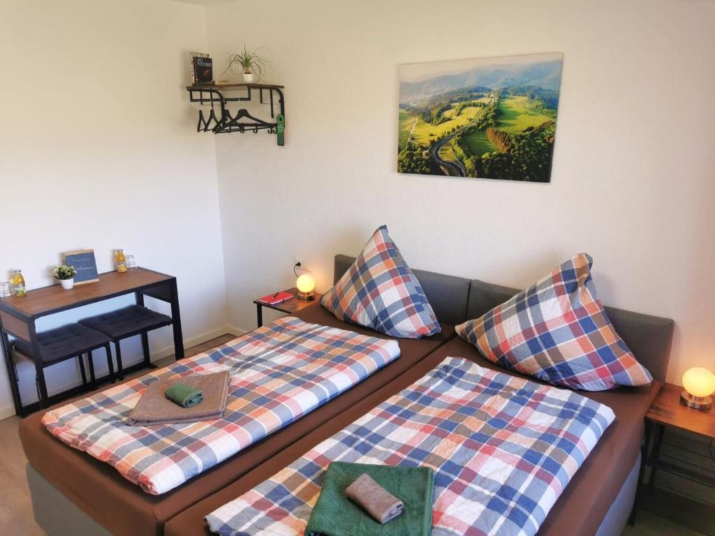 a living room with two beds and a table at Speedy's Gästehaus in Reimerath