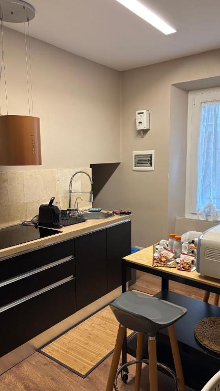 a kitchen with a sink and a counter with a table at LePetit in Porto Santo Stefano