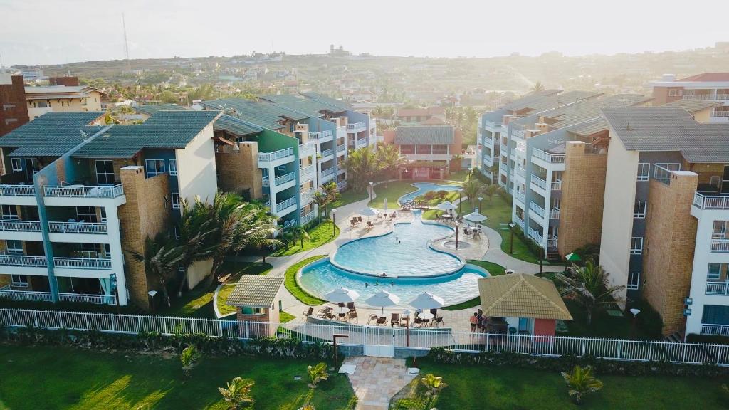 an aerial view of an apartment complex with a swimming pool at TerraMaris - Pé na Areia e Vista Mar Deslumbrante in Aquiraz