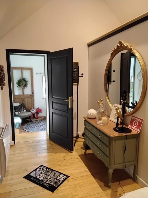 a dressing room with a mirror and a dresser at Au petit bonheur de séraphine in Saint-Aubin